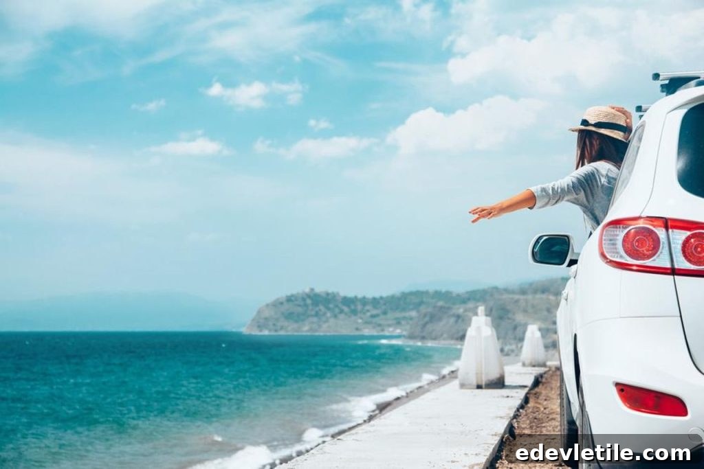 A girl going on a road trip through Turkey in a white car, holding out her hand, with the sea near the road