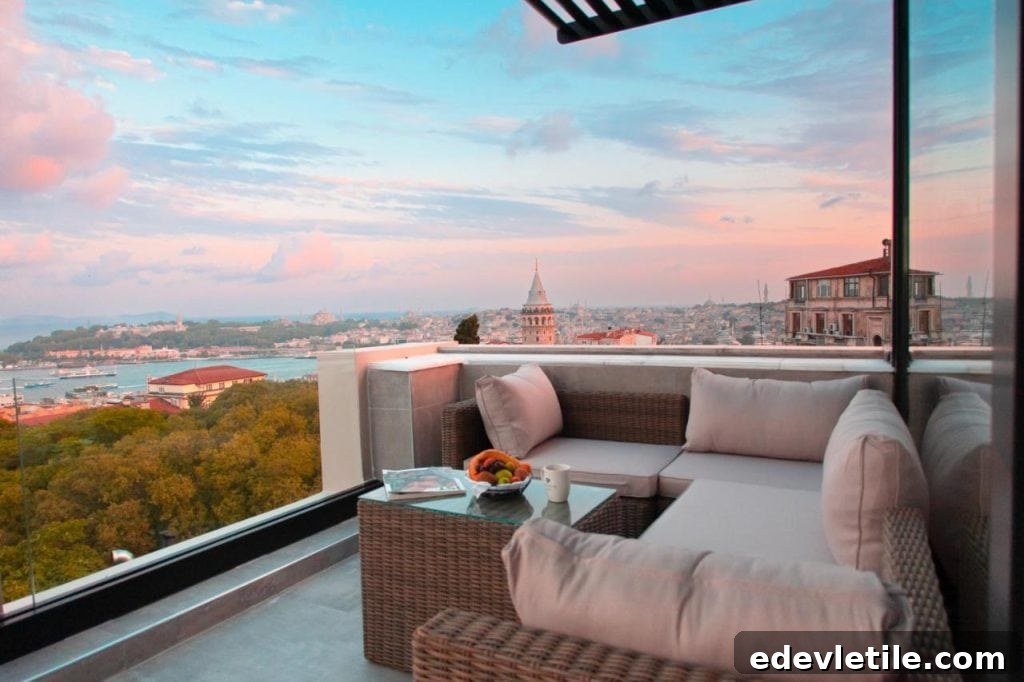 Comfortable corner sofa on a glass-railed terrace with sweeping views of the Galata Tower, Bosphorus, and Istanbul skyline at sunset.