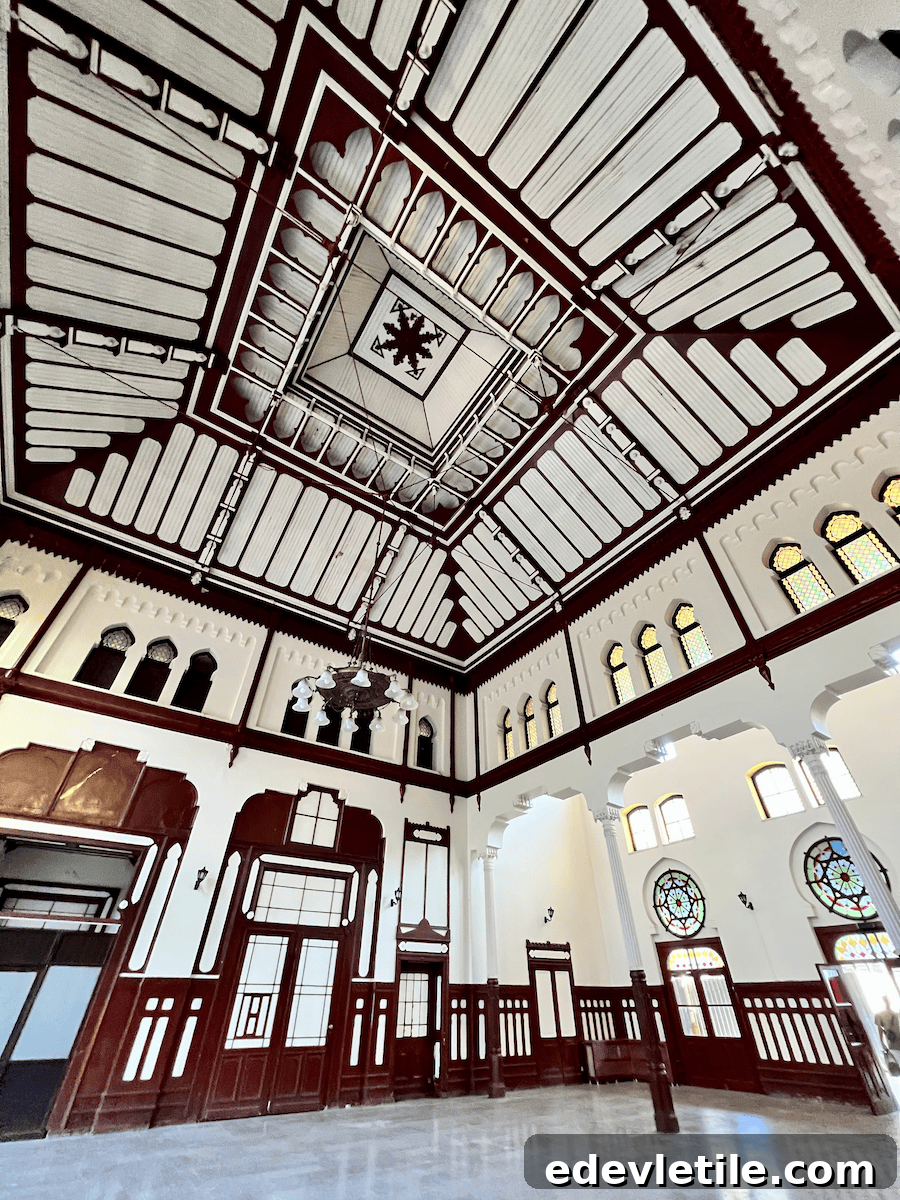 Interior of the grand waiting hall at Sirkeci Station in Istanbul, with high ceilings, intricate woodwork, stained glass windows, and Ottoman-European architectural details.