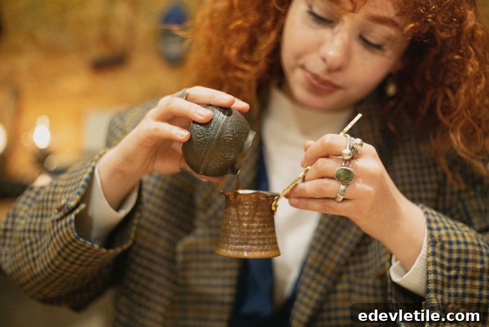 Close-up of a woman carefully pouring into a traditional Turkish coffee pot called a cezve during a hands-on coffee workshop in Istanbul.