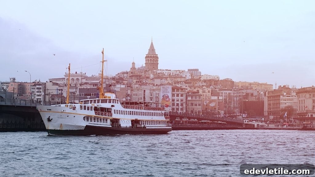 Passenger ferry crossing the Bosphorus with Galata Tower and Istanbul skyline in the background, representing ferry travel between Sabiha Gokcen Airport and Sultanahmet.