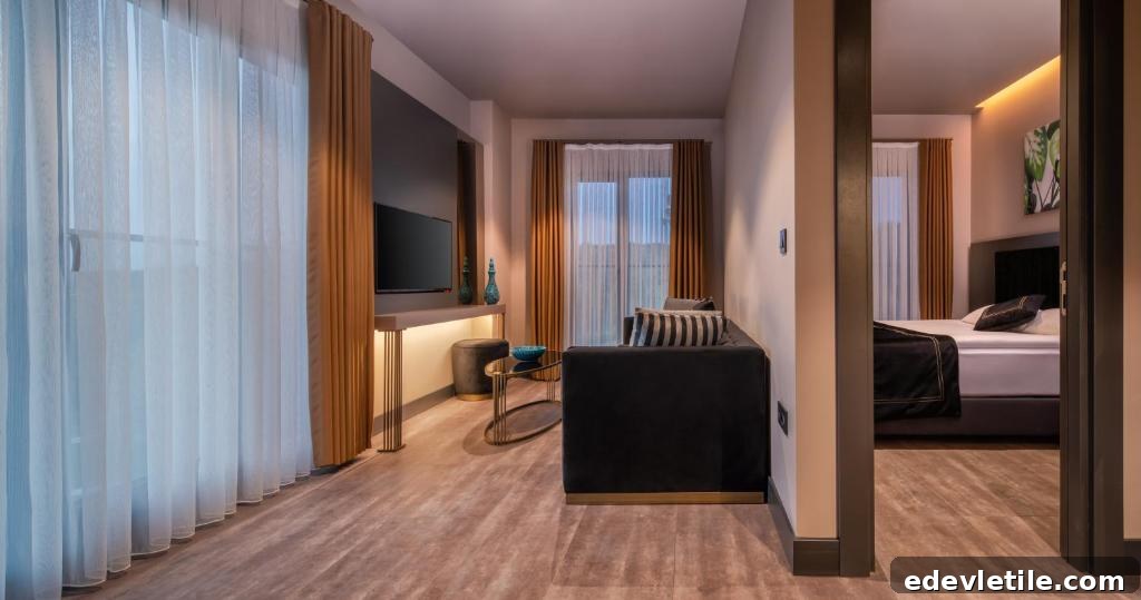 Suite interior at Menalo Airport Hotel, featuring a separate living room with modern decor and warm lighting.