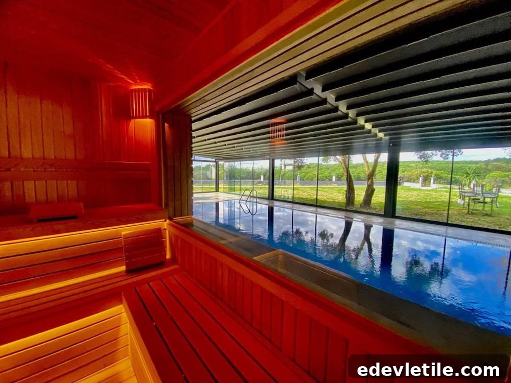View from a wooden sauna overlooking a serene indoor pool at Green Roof Airport Hotel, with large windows and garden views.