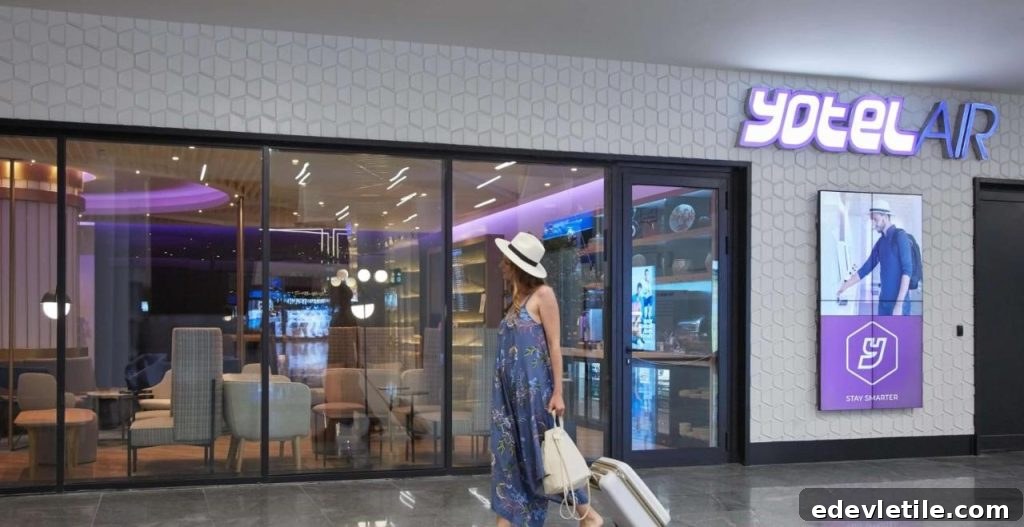 Entrance to YOTEL AIR at Istanbul Airport, with a woman in a hat walking past the glass-fronted lounge area.