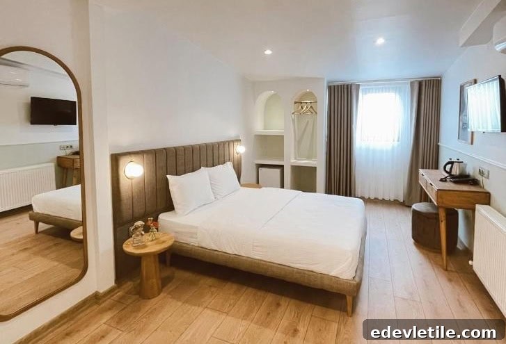 Spacious and bright room at Meshk Hotel Istanbul Airport, with wood flooring, neutral tones, and minimalist furnishings.