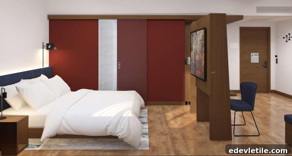 Contemporary hotel room at Hampton by Hilton Istanbul Airport, featuring wood floors, a red sliding door, and a work area.