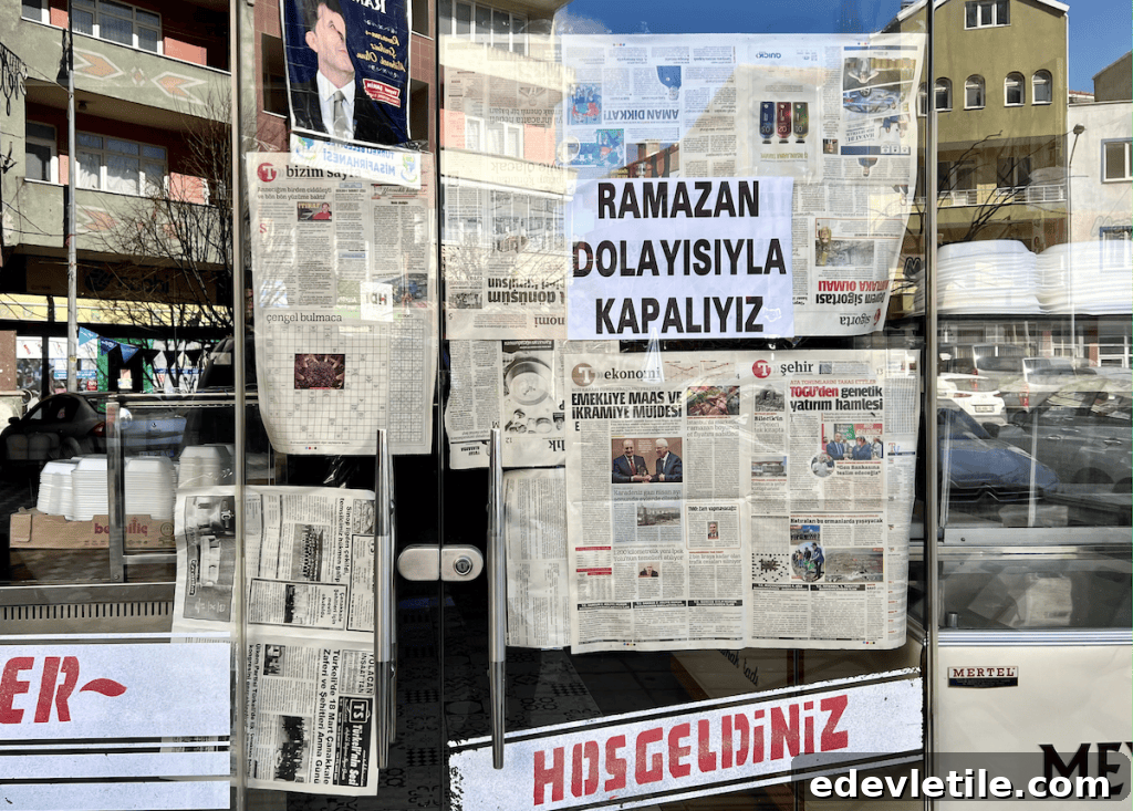 Glass storefront covered with newspaper and a printed sign in Turkish reading “Ramazan Dolayısıyla Kapalıyız” ("Closed for Ramadan").