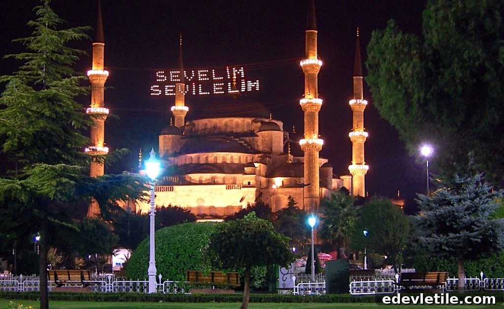 Blue Mosque illuminated at night with a Ramadan light banner strung between its minarets, reading “Sevelim Sevilim” ("Let’s love and be loved").