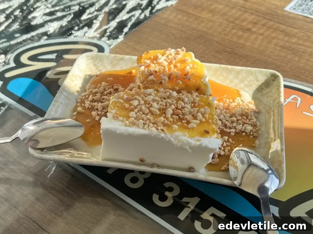 Traditional Amasra dessert made of creamy white yogurt topped with honey and chopped walnuts, served with spoons for sharing.