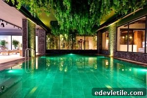 Indoor luxury pool framed by lush hanging greenery and mood lighting, offering a serene and upscale retreat in Bodrum.