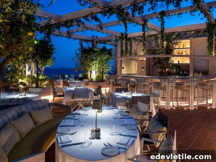 Elegant rooftop restaurant in Turgutreis at dusk, with white tablecloths, lush greenery, and atmospheric lighting under a wooden trellis.