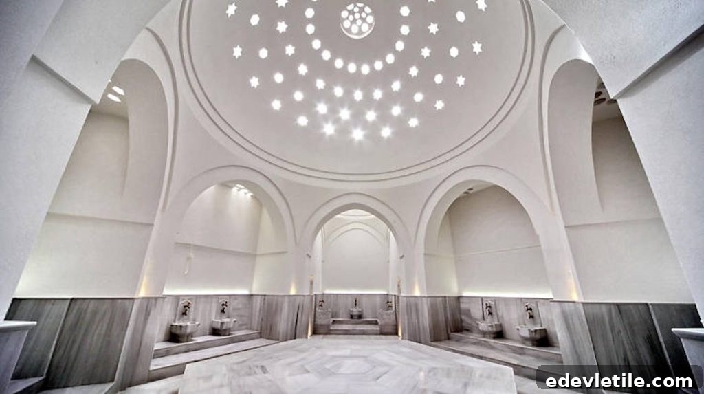 Bright, white marble Turkish hammam with domed ceilings and star-shaped light patterns; a peaceful, traditional bathhouse interior.