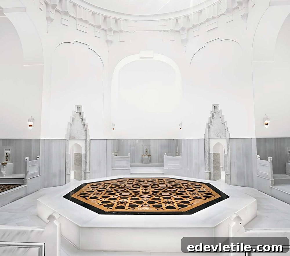 Minimalist white Turkish hammam (Hurrem Sultan Hamam) with geometric patterned heated marble platform and elegant architectural arches.