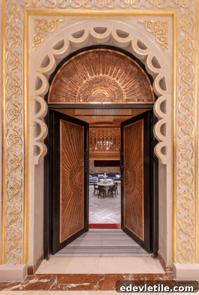 Ornate arched doorway with carved gold details and open wooden doors revealing a luxurious lounge area inside Çatma Mescit Hamam.