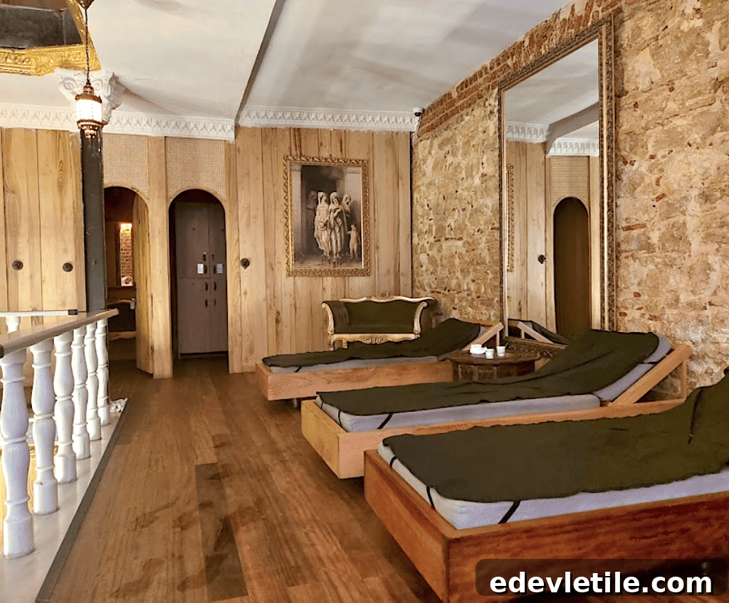 Rustic-chic lounge at Aga Hammam featuring wooden walls, stone accents, and cushioned daybeds for guests to unwind post-treatment.
