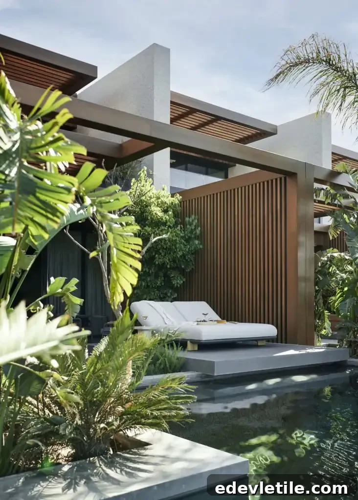 Modern honeymoon villa in Bodrum with lush greenery, a private patio, and sun loungers beside a tranquil pool.