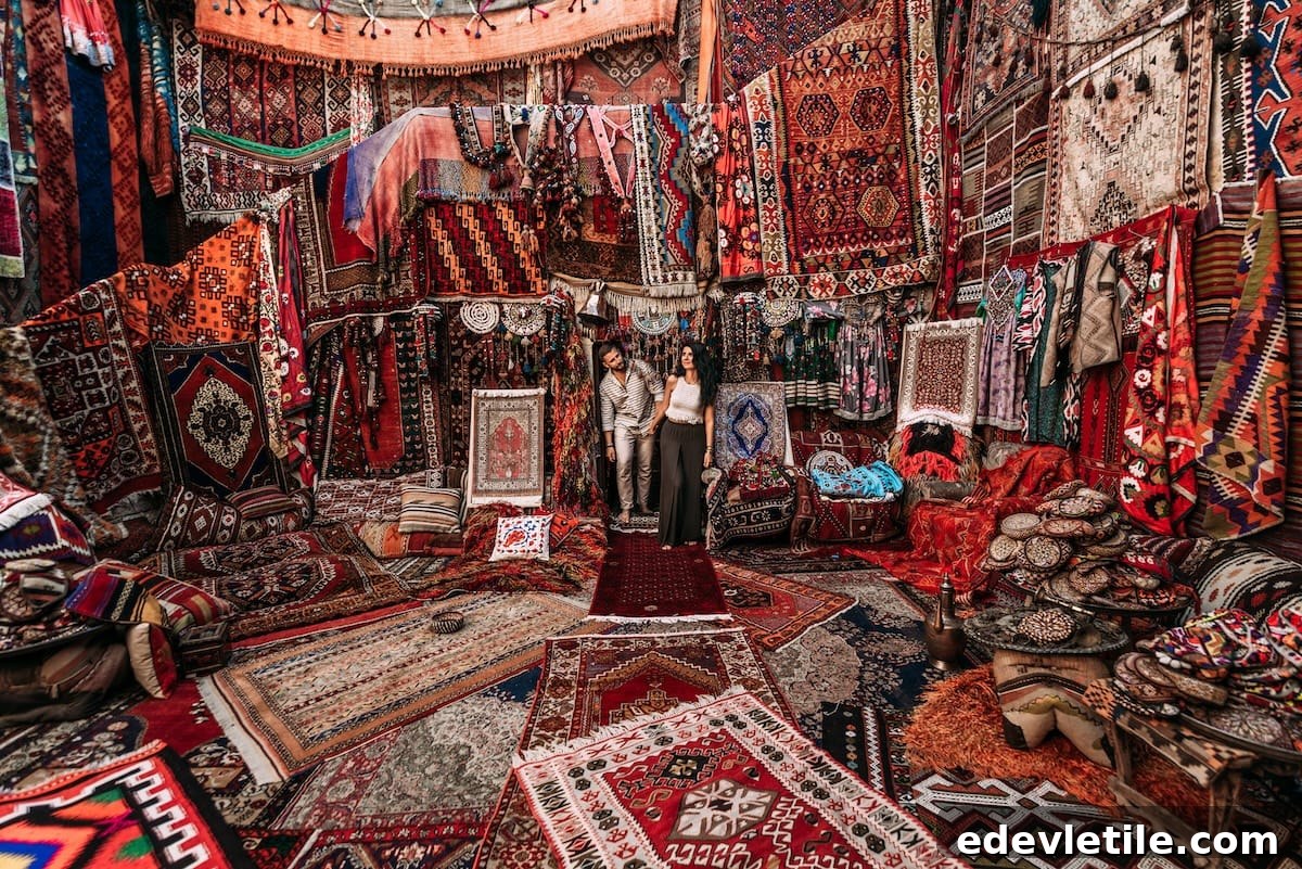 Couple browsing an elaborate carpet shop filled with vibrant handmade Turkish rugs and traditional decor in Cappadocia.