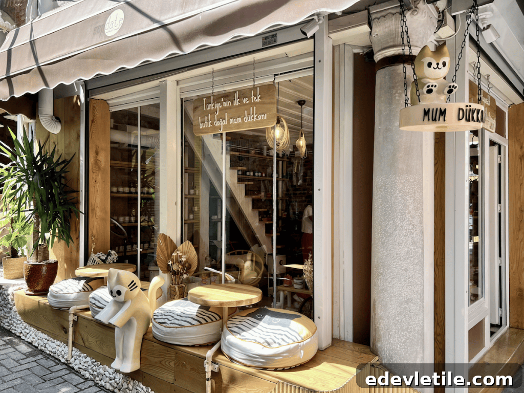 Playful storefront of Mum Dükkanı, a boutique candle shop in Balat, with striped cushion seating, wooden accents, and a sign featuring a cute cartoon cat.