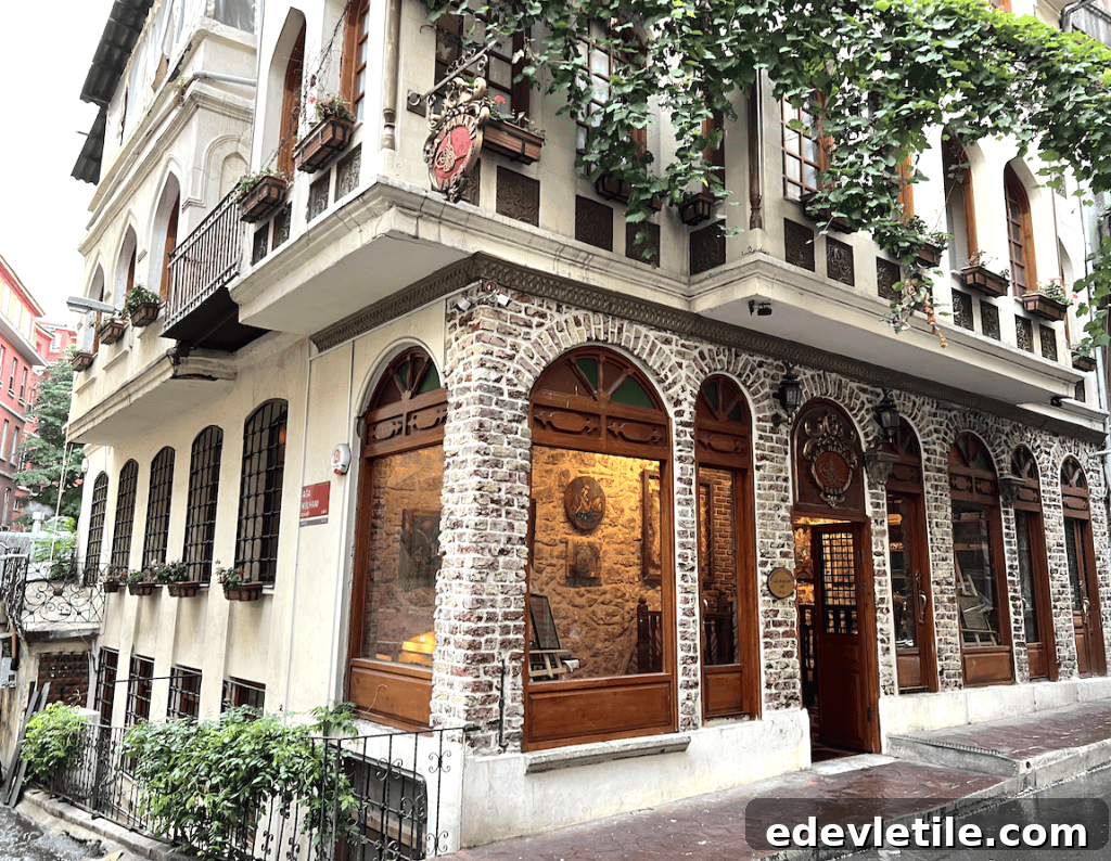 Street view of the charming historic Aga Hammam building with arched wooden windows, ivy-covered balconies, and stone facade.