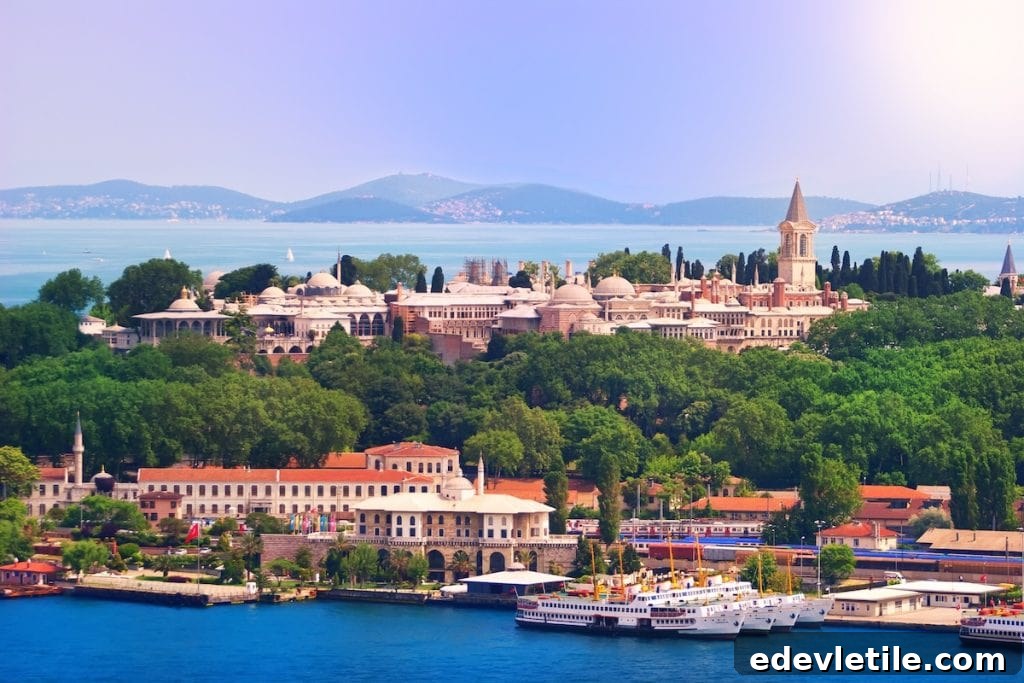 Panoramic shot of Topkapi Palace surrounded by lush greenery, with the Bosphorus and Princes' Islands visible in the background.