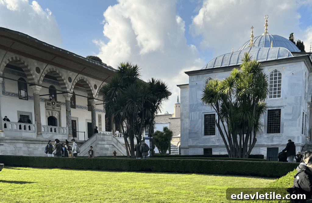 Visitors walk near the elegant Audience Hall and the domed Enderun Library in Topkapi Palace’s Third Courtyard.