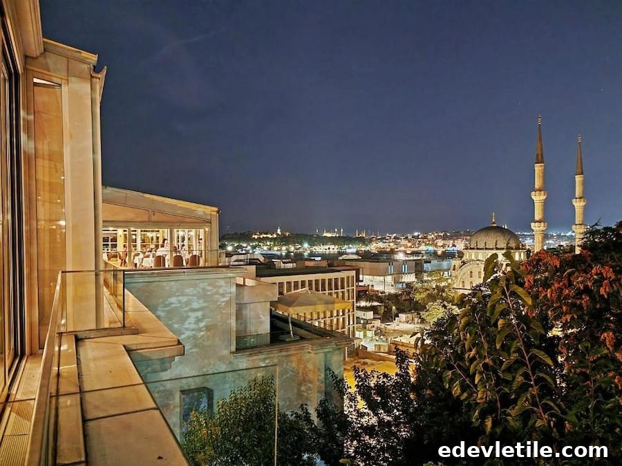 Nighttime view from Port Bosphorus Hotel showing a glowing Istanbul skyline with mosques and minarets lit against the dark sky.