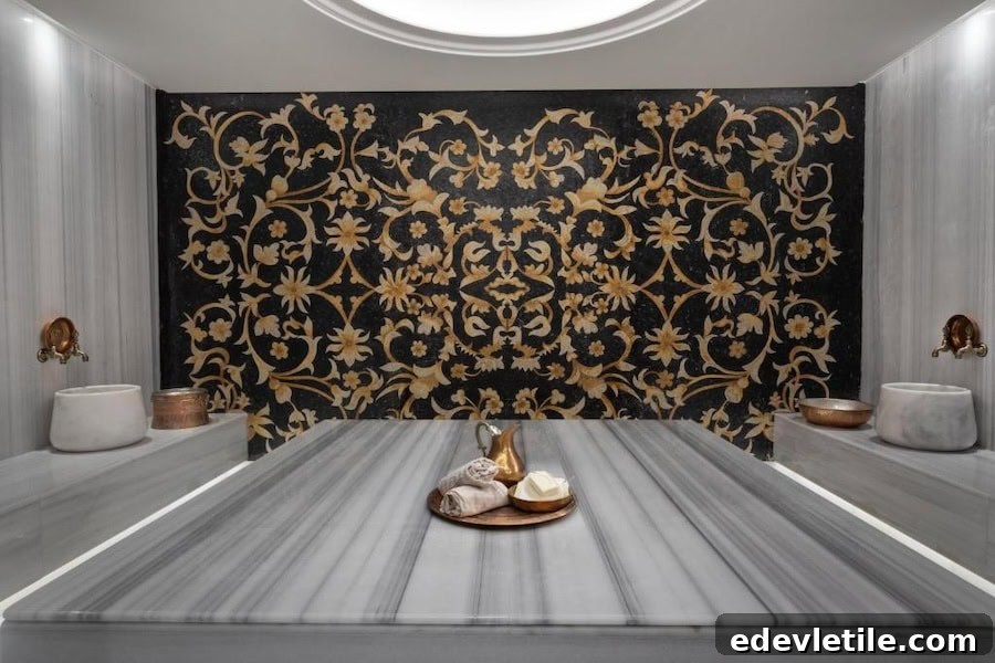 Elegant marble Turkish hammam at Burdock Hotel Istanbul with intricate gold-accented tilework and traditional copper wash bowls.