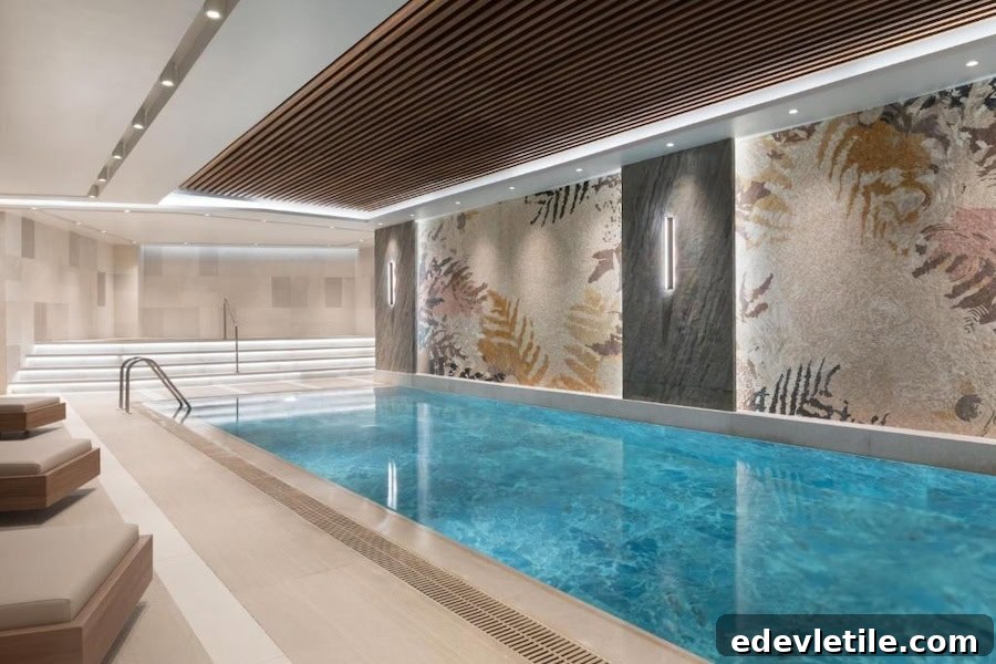 Indoor pool area at Burdock Hotel Istanbul, with a sleek design, lounge chairs, and a feature wall decorated with abstract botanical patterns.