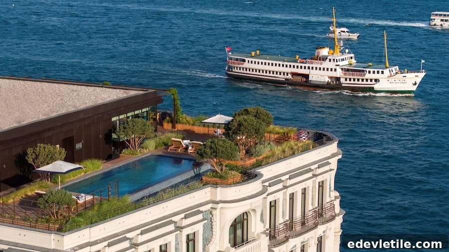 Rooftop garden and pool at The Peninsula Istanbul overlooking the Bosphorus, with a historic ferry gliding past in the background.