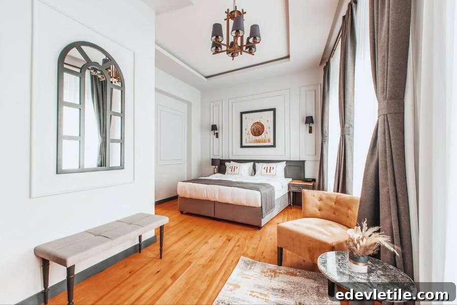 Bright, stylish guest room at Ferman Port Hotel with tall windows, high ceiling, and classic European-inspired furnishings.