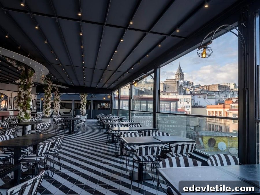 Covered rooftop terrace at Ferman Port Hotel with black-and-white decor and panoramic views of Galata Tower and surrounding buildings.