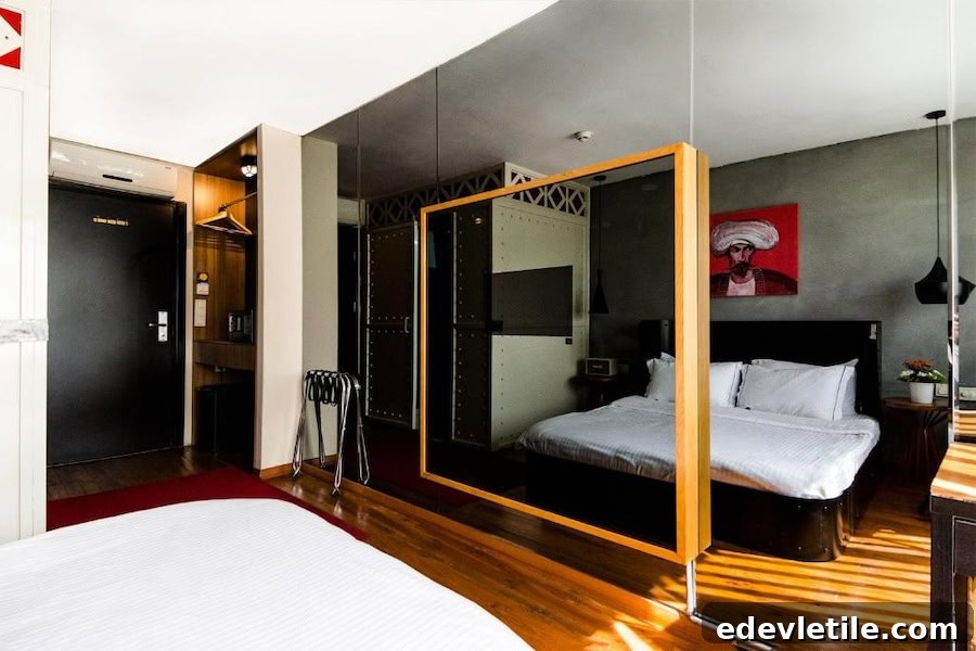 Modern boutique-style room at SuB Karaköy featuring creative decor, mirrored accents, and a bold painting of a figure in Ottoman attire.