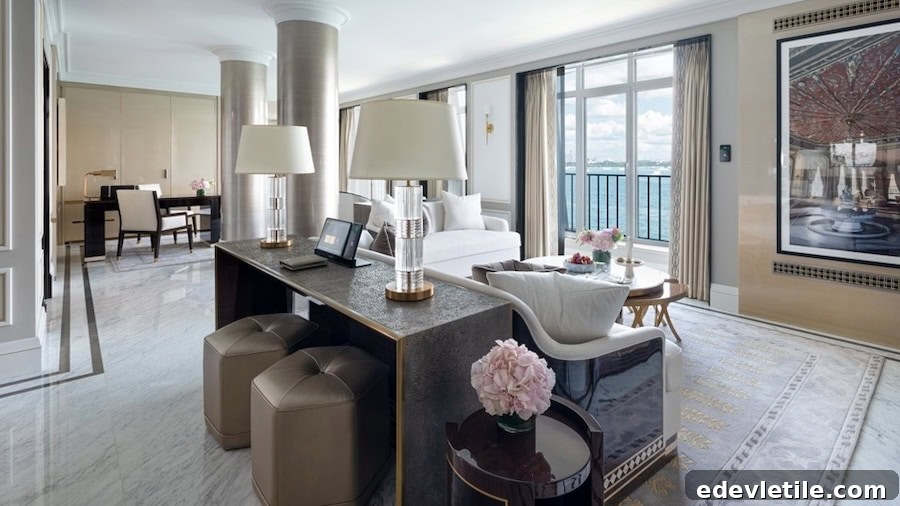 Spacious, light-filled suite at The Peninsula Istanbul with elegant furnishings, a marble floor, and a balcony view of the Bosphorus.