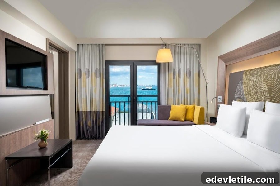 Comfortable, modern hotel room at Novotel Istanbul Bosphorus with a sea-facing balcony and bright, contemporary decor.