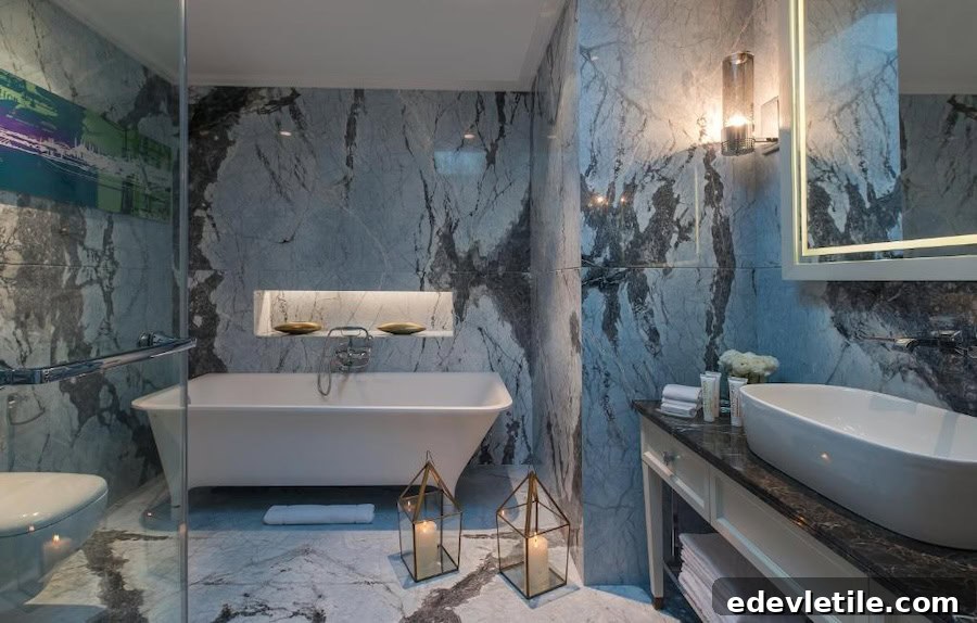 Luxurious marble bathroom at 10 Karaköy Hotel, featuring a deep soaking tub, glass shower, and candlelit accents.