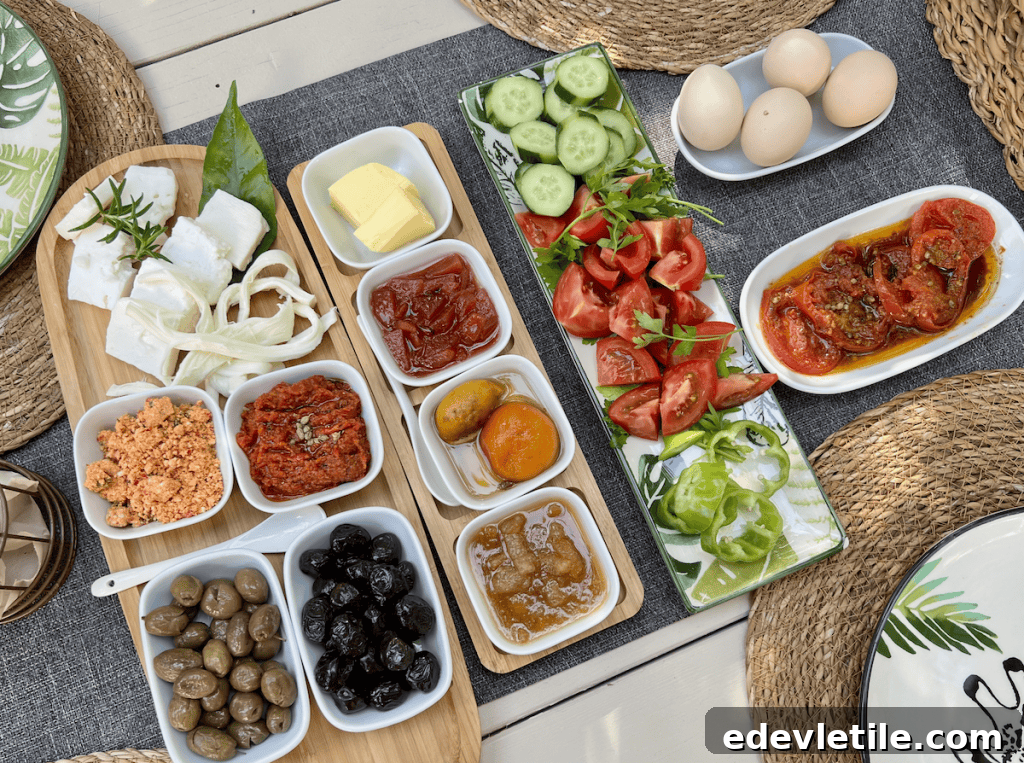 A colorful vegetarian Turkish breakfast spread with fresh tomatoes, cucumbers, olives, cheeses, eggs, and dips, artfully arranged on a woven placemat, taken on a vegetarian food tour in Istanbul