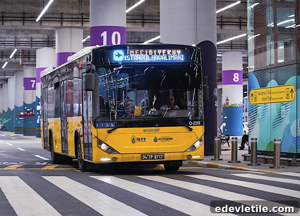 Yellow IETT public bus at the Istanbul Airport bus platform with a digital sign reading Mecidiyekoy Istanbul Havalimani. This image illustrates the budget friendly public bus option from IST Airport into the city.