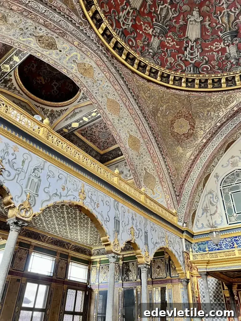 Highly decorated interior hall inside Topkapi Palace with gold details painted ceilings and marble columns showcasing historic places to visit during a layover in Istanbul.