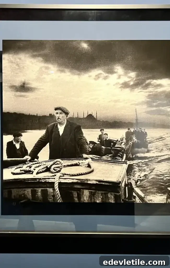 Black and white photograph of fishermen on the Bosphorus with Istanbul’s skyline in the distance at the Ara Guler Museum.