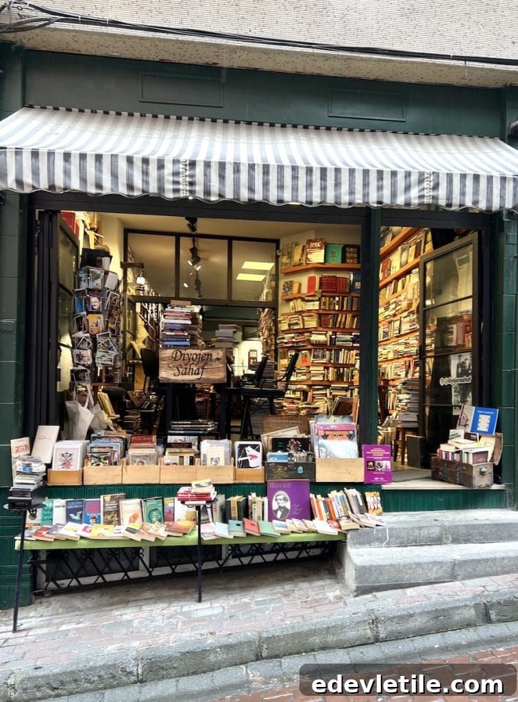 Independent secondhand bookshop in Besiktas with shelves stacked to the ceiling and books displayed outside on the steps.