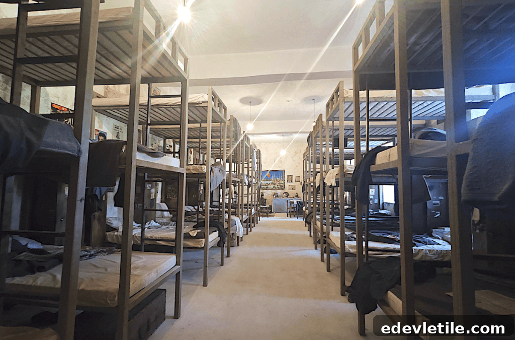 A room in Sinop Prison full of bunk beds and personal artifacts.